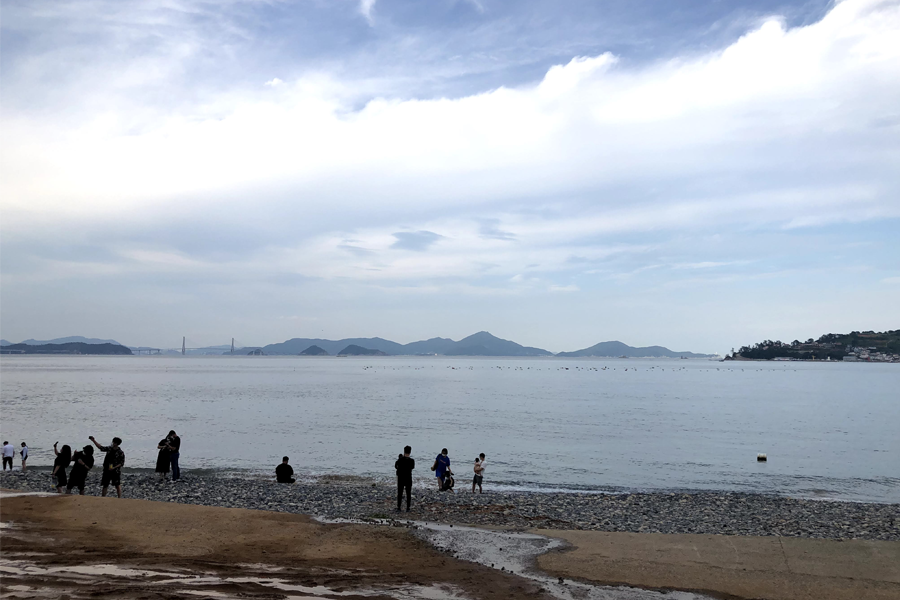 People on the beach in front of Maemi Castle on Geoje Island