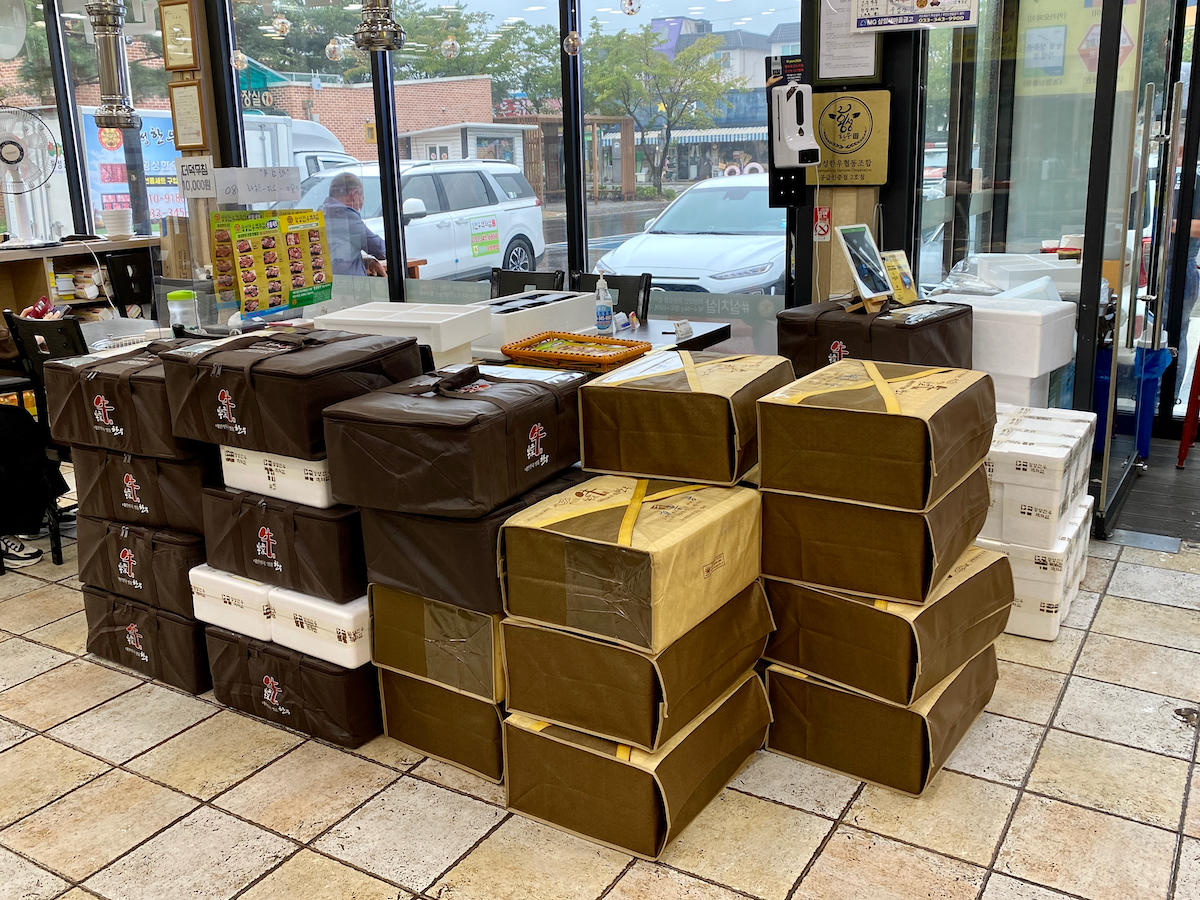 Hoengseong Hanwoo Village restaurant showing stacks of Korean beef prepared for shipment