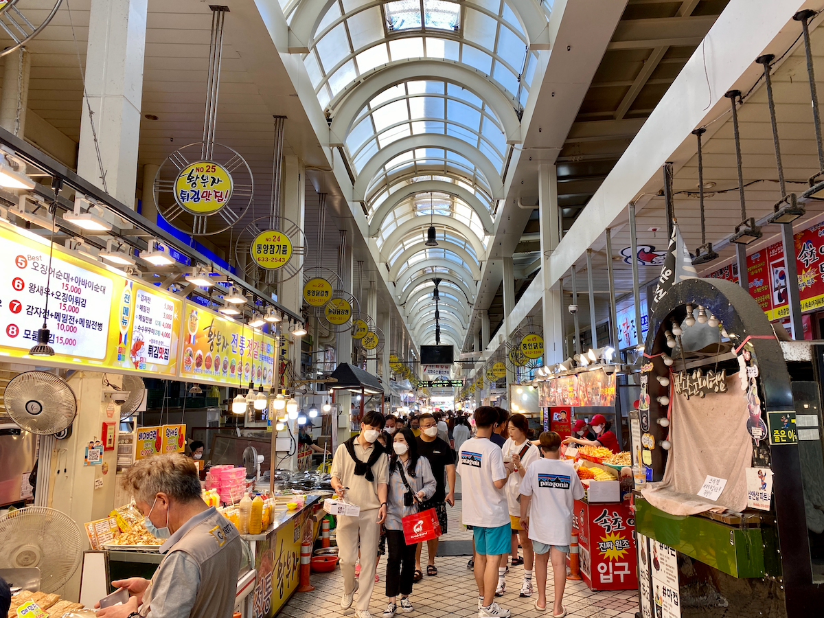 crowd walking down the hall of sokcho central market