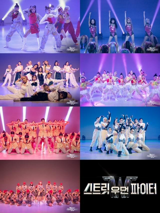 STREET WOMAN FIGHTERのダンスチームによるパフォーマンスシーン。多様な色のスポットライトの下で個性豊かな衣装を着たダンサーたちが力強い姿勢で踊っている。背景には独特のセットと鮮やかなライトが配置されている。