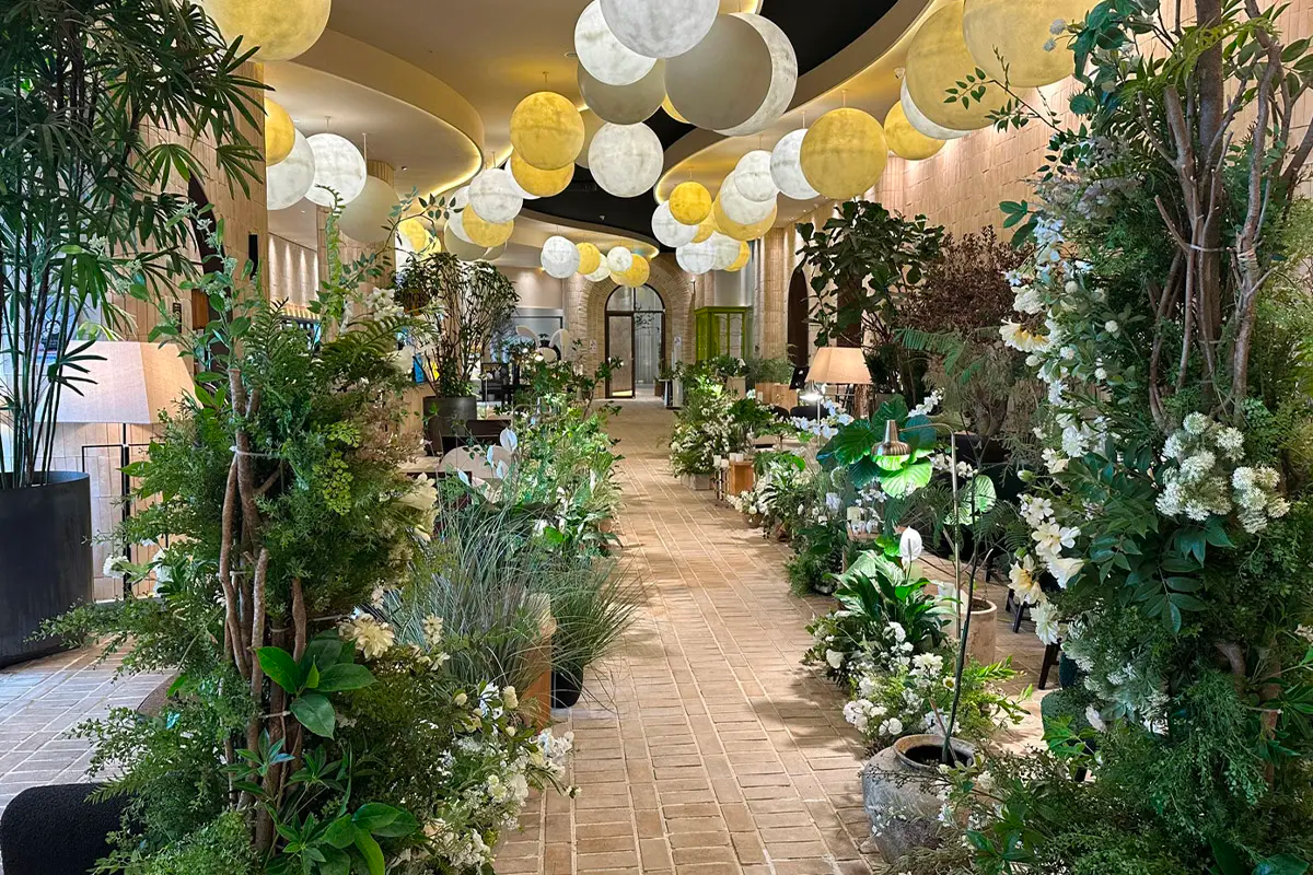 釜山机张大满月餐厅内景，灯光照明下的绿植走廊，提供惬意用餐环境。