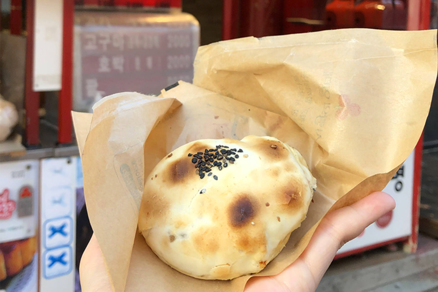 A freshly baked bun held in hand from Shili Xiang bakery in Incheon