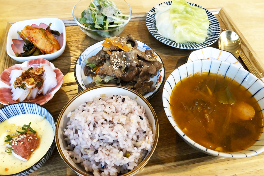 Traditional Korean set meal served at a restaurant in Incheon, South Korea, featuring rice, soup, and various side dishes in colorful bowls.
