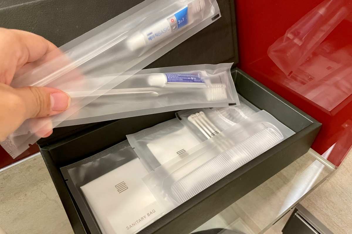 A box filled with toiletries like a toothbrush, cotton swabs, and more.