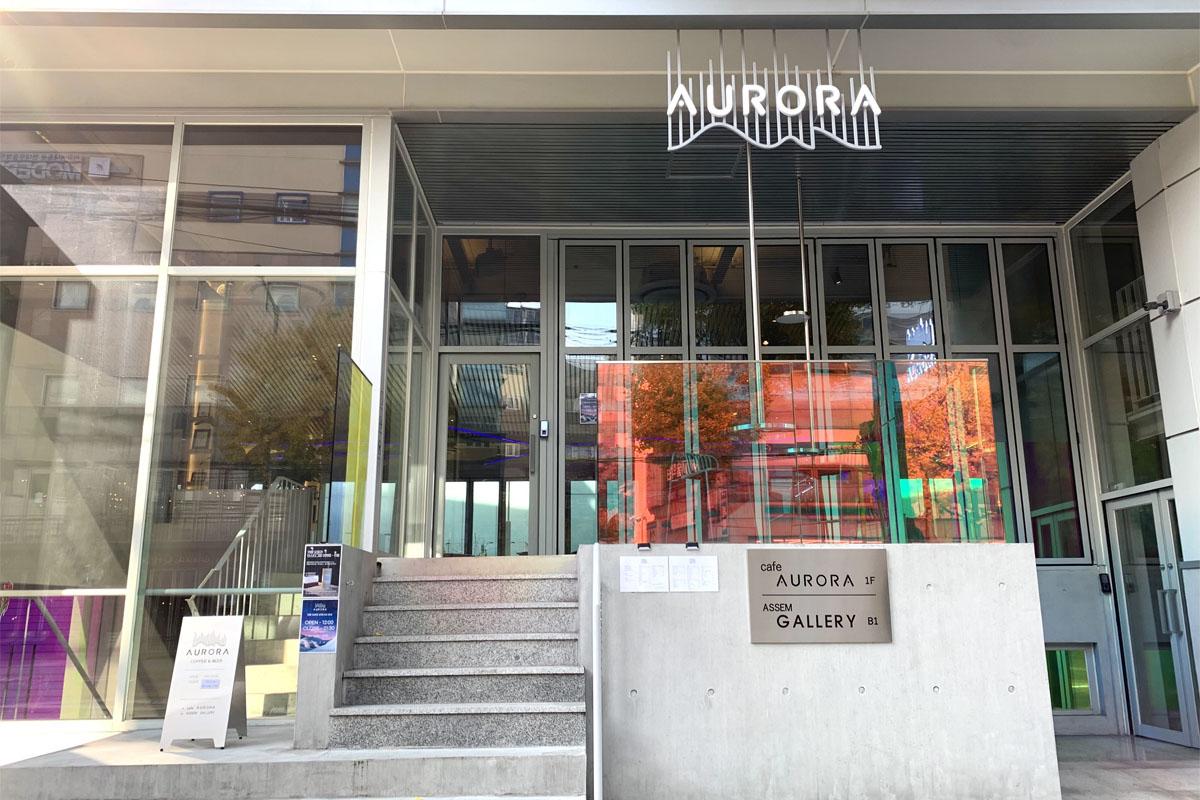 入口，充满绚丽极光的弘大AURORA咖啡馆，颜色鲜明的玻璃窗和现代化建筑。