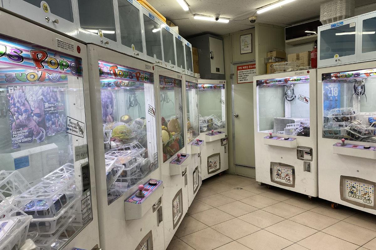 Interior of a claw machine store in Seoul featuring rows of colorful and appealing prize machines