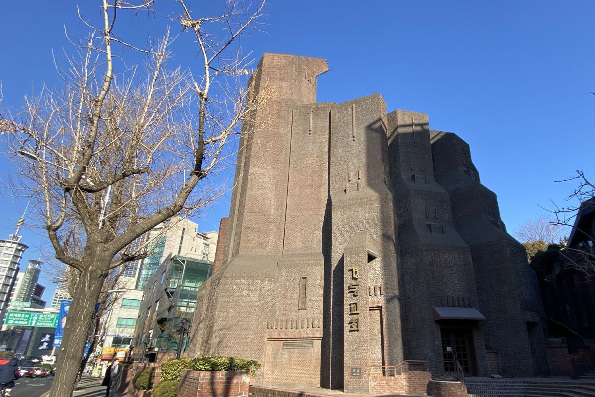 Exterior of Gyeongdong Church in Seoul featuring unique modern architecture resembling praying hands