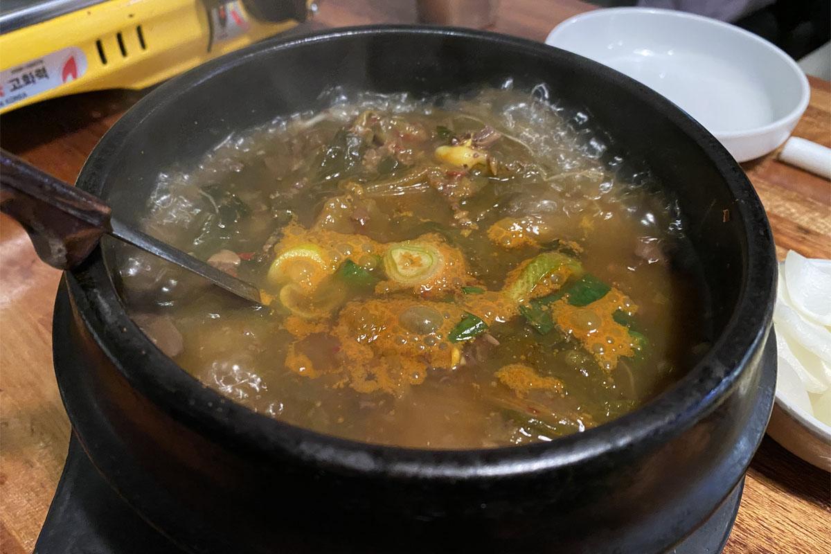 弘大飽肚烤腸的牛血湯，端上餐桌呈現熱氣騰騰的樣貌。