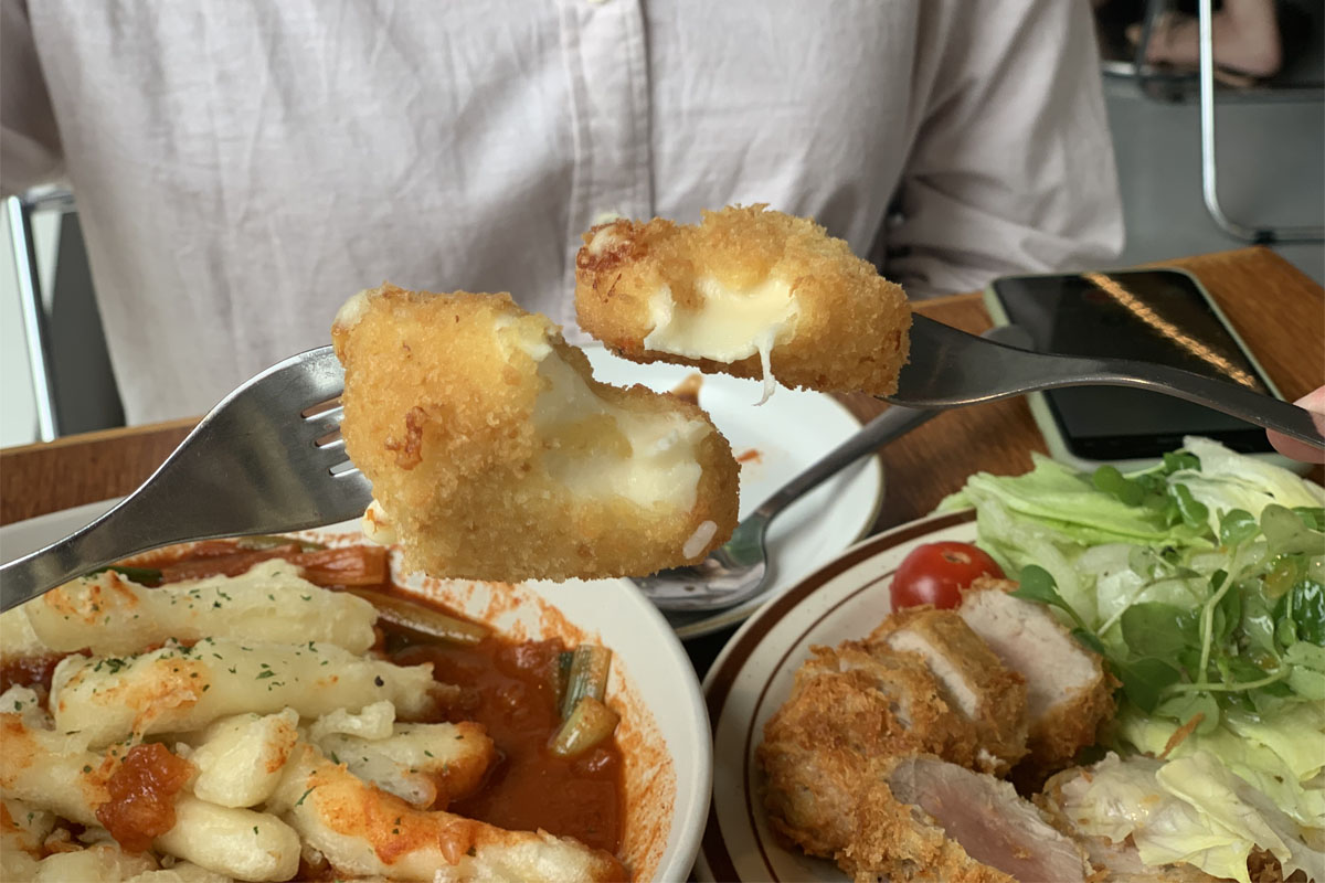 Tarjetas de Happy Cheese Smile disponibles para los clientes, con colores rojo y amarillo, en una cesta metálica.