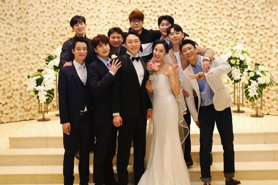 新郎在婚礼现场演唱祝歌，背景乐队和乐器表演，体现韩国婚礼的个人献唱文化