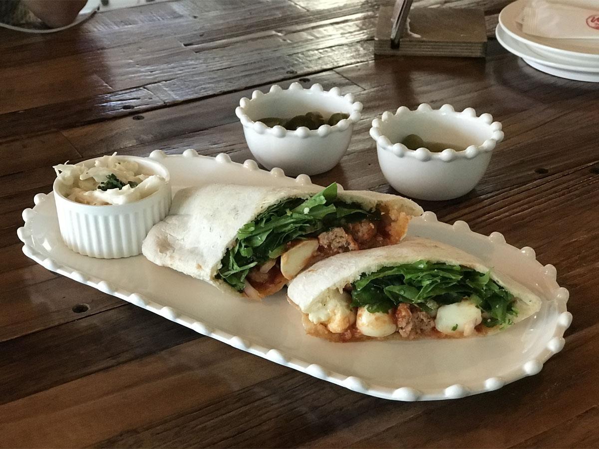 A picture of an Italian Sausage Sandwich.