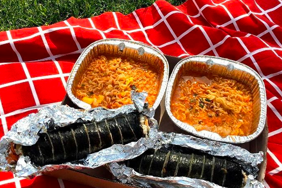 Instant noodles displayed in aluminum bowls, ready for enjoying at a picnic, showcasing a popular Korean eating experience.