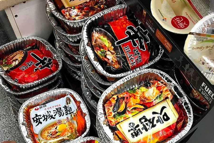 Various packaged ramen displayed in a convenience store, highlighting the abundance of instant noodle options in Korea.