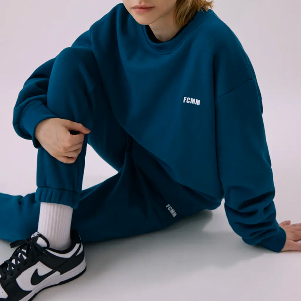 Vintage Green FCMM Club Essential sweater, boasting both comfort and a fashion-forward look.