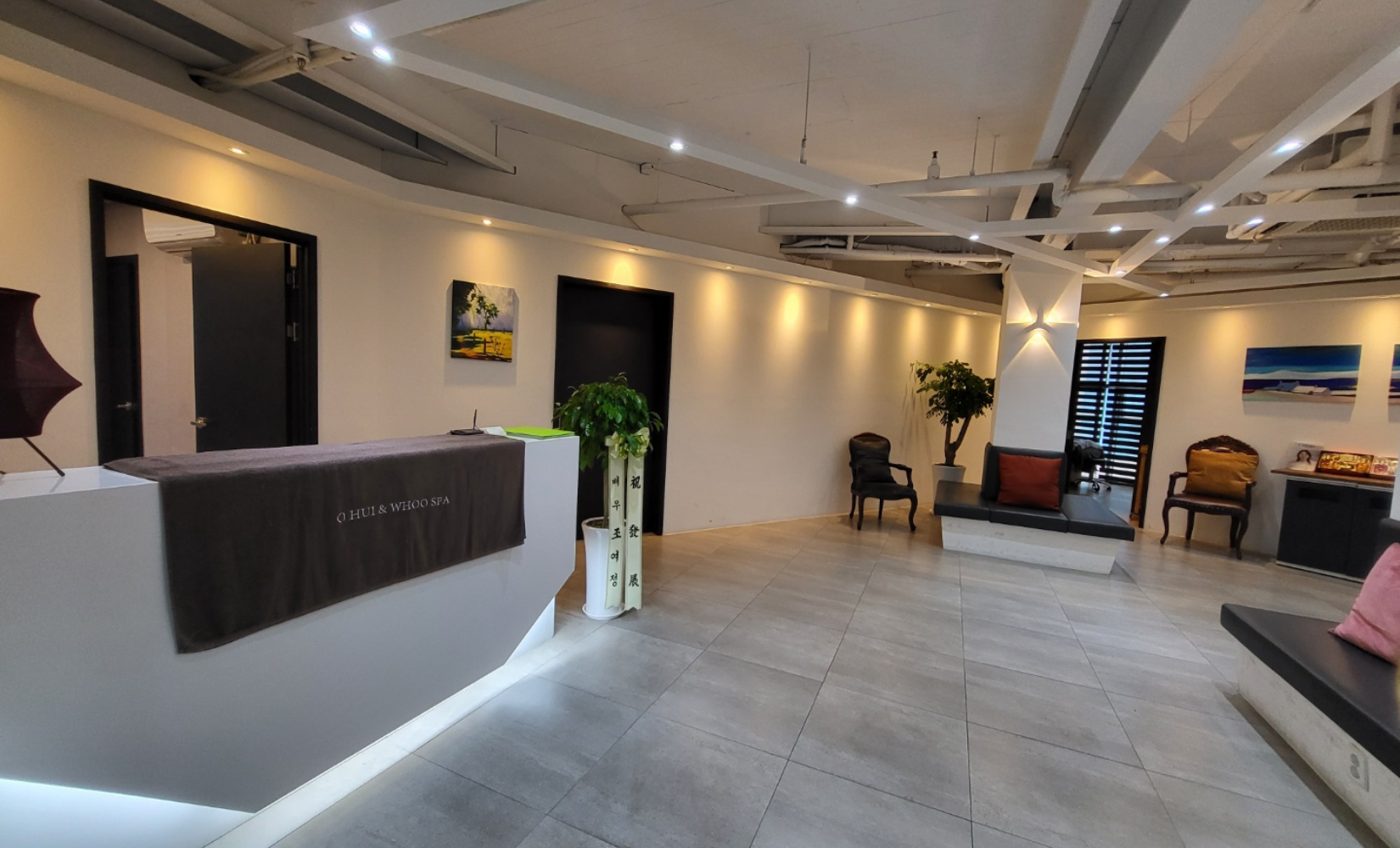 Interior view of Ohui & Whoo Spa lobby with modern design, warm lighting, and comfortable seating in Myeongdong, Seoul.