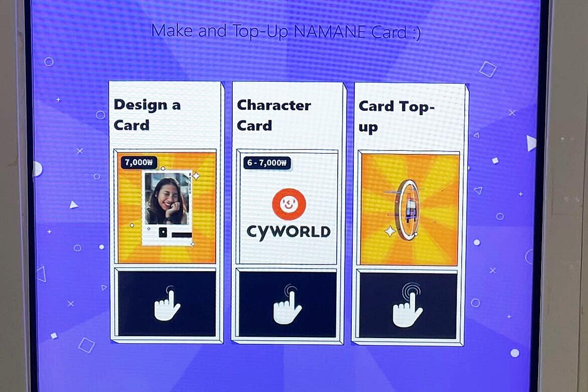 Close-up view of a NAMANE card kiosk displaying options to design, choose character card, or top-up.