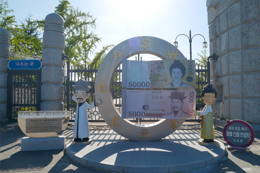 韓國江陵烏竹軒的紀念碑，顯示₩5,000和₩50,000紙幣，代表著朝鮮時代重要人物的故居及其文化與歷史意義。