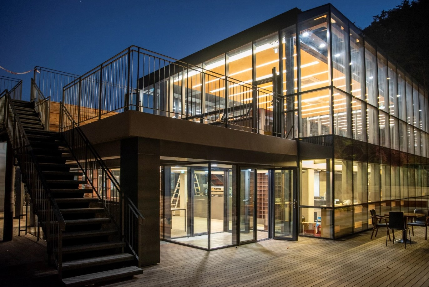 The modern glass structure of The Forest Choso Chaekbang, a unique bookstore located on the slopes of Inwangsan, Seoul.