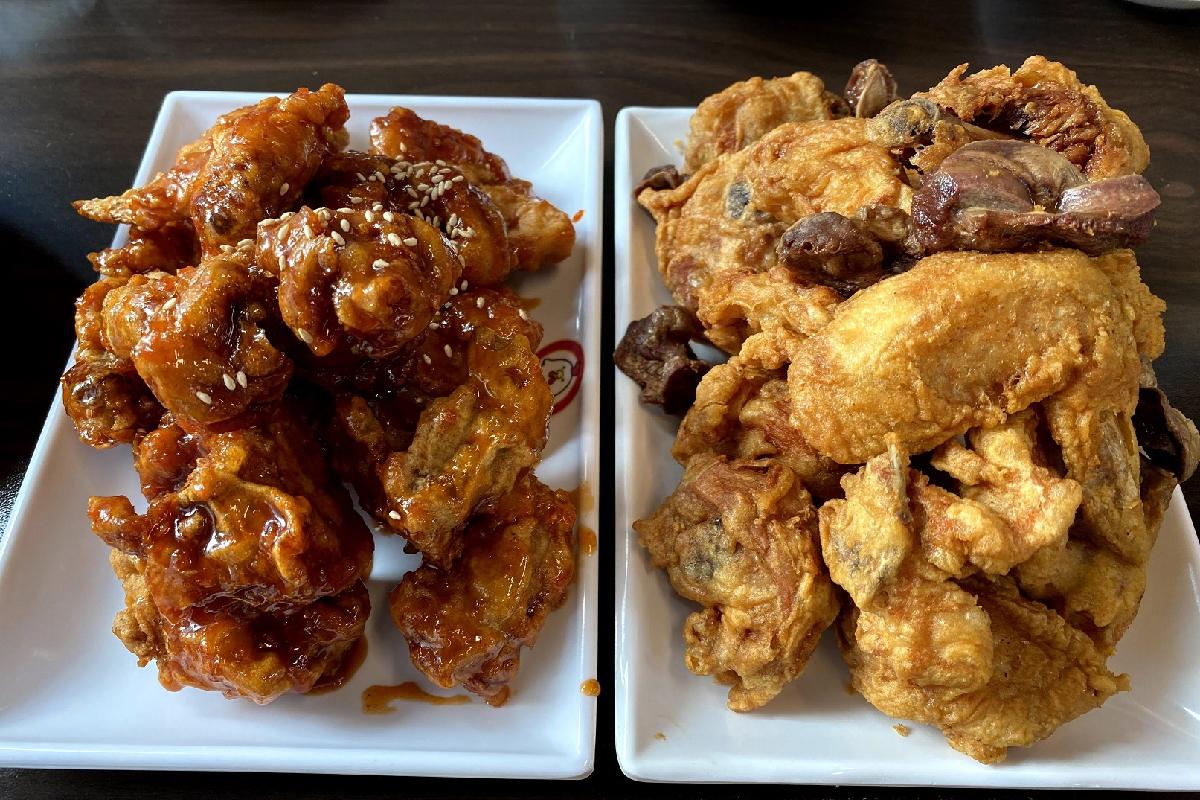 A mouth-watering display of crispy Suwon fried chicken, perfectly cooked and golden brown with a sticky, sweet sauce.