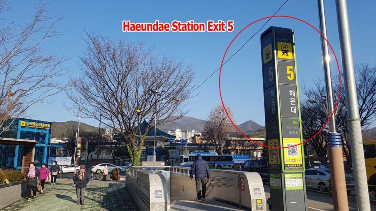 Haeundae Station Exit 5 with pedestrian walkway and transportation signs.