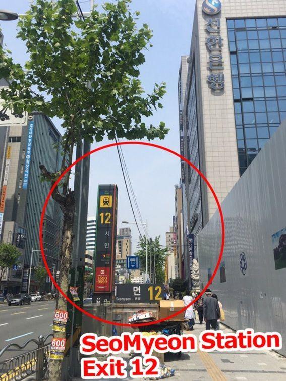 Seomyeon Station Exit 12 street view with surrounding buildings and signage.