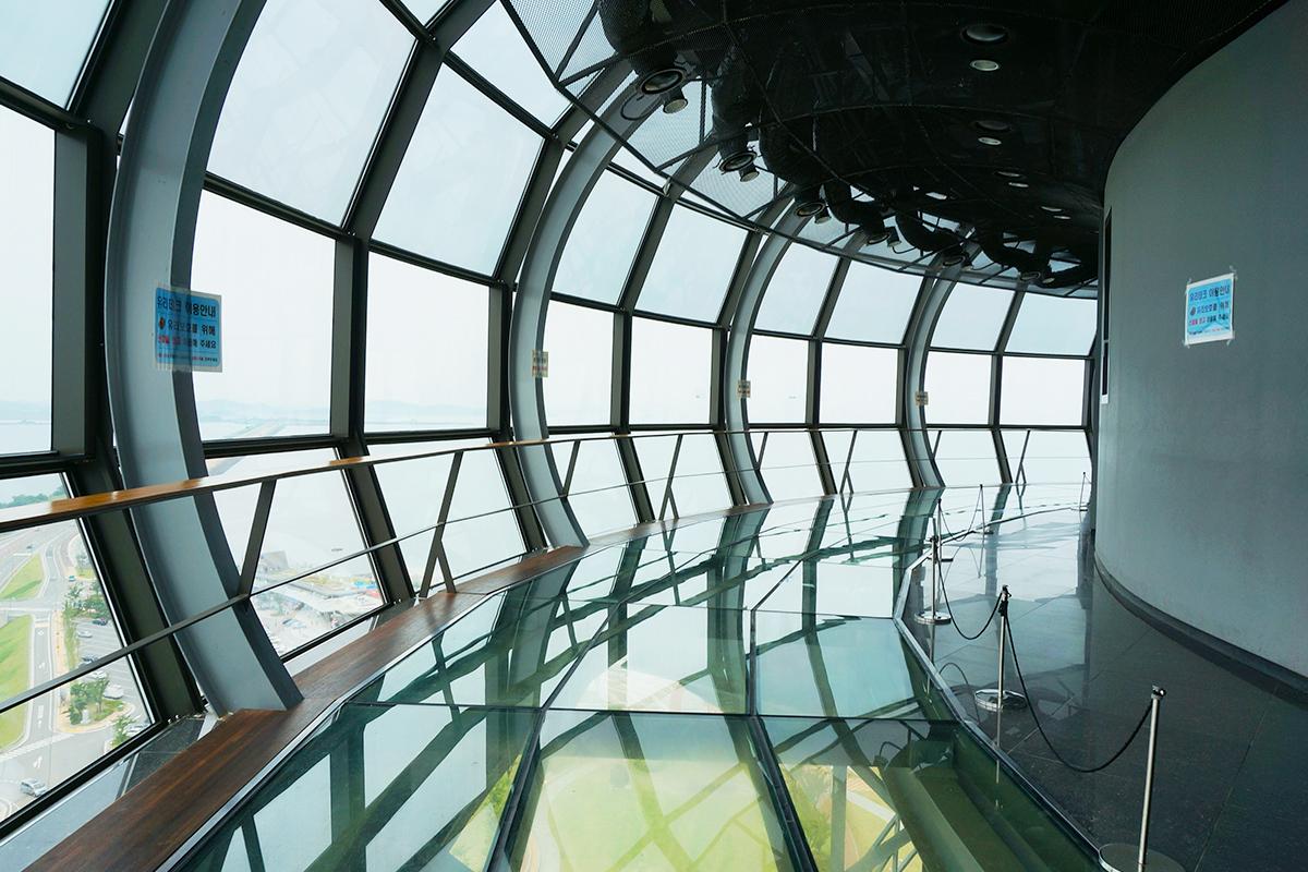 Interior shot of the Moon Observatory in South Korea, showcasing the large glass windows and the panoramic view they offer.