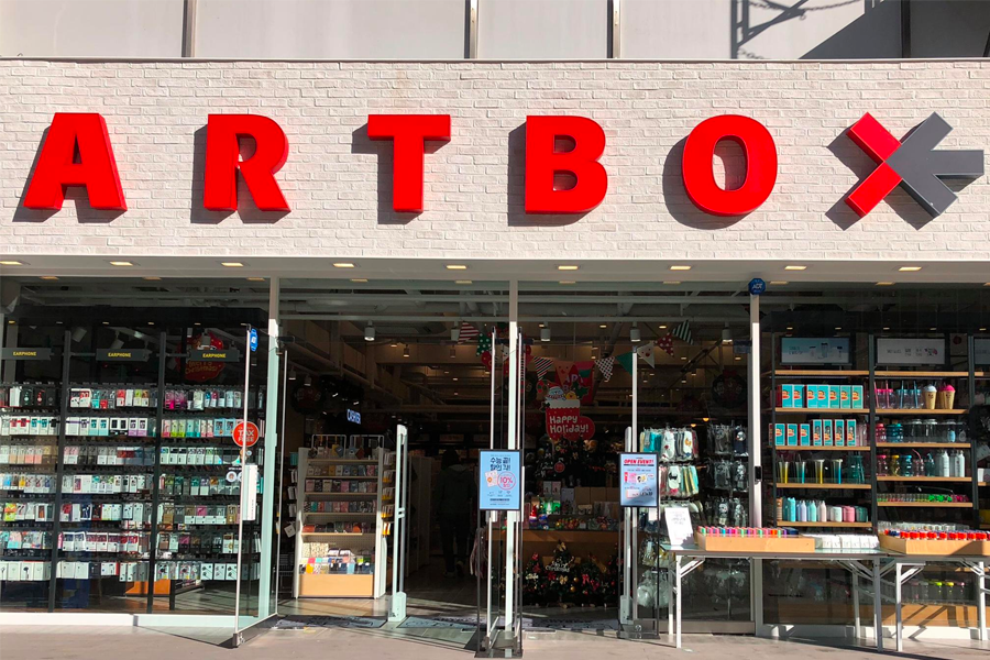 Front view of ARTBOX store with clear glass doors and vibrant product display in Daegu, South Korea.