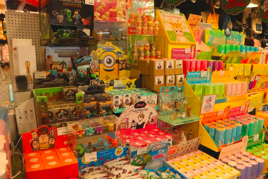 Close-up of colorful and diverse products including toys and stationery items displayed inside a Korean ARTBOX store.