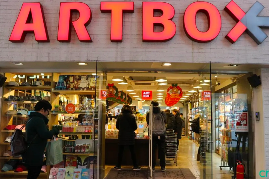 ARTBOX store exterior in Seoul, South Korea with bright red signage and a variety of products displayed near the entrance.