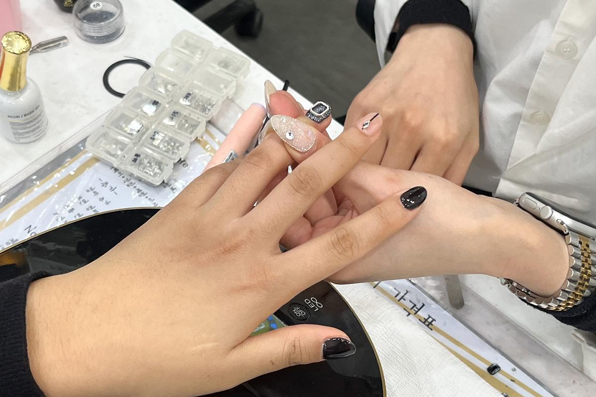 Technician fine-tuning nail design at Ohneulgwa Dareun Nail Salon with precision and care.