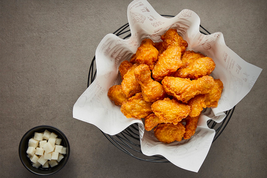 Crispy Kyochon Fried Chicken pieces served at a branch in Daegu, Korea with pickled radish on the side.