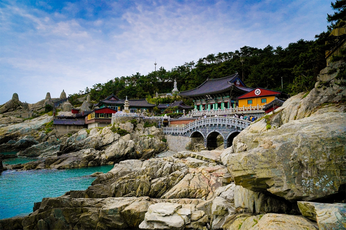 Haedong Yonggungsa Temple scenic view with its traditional Korean architecture and lush greenery.