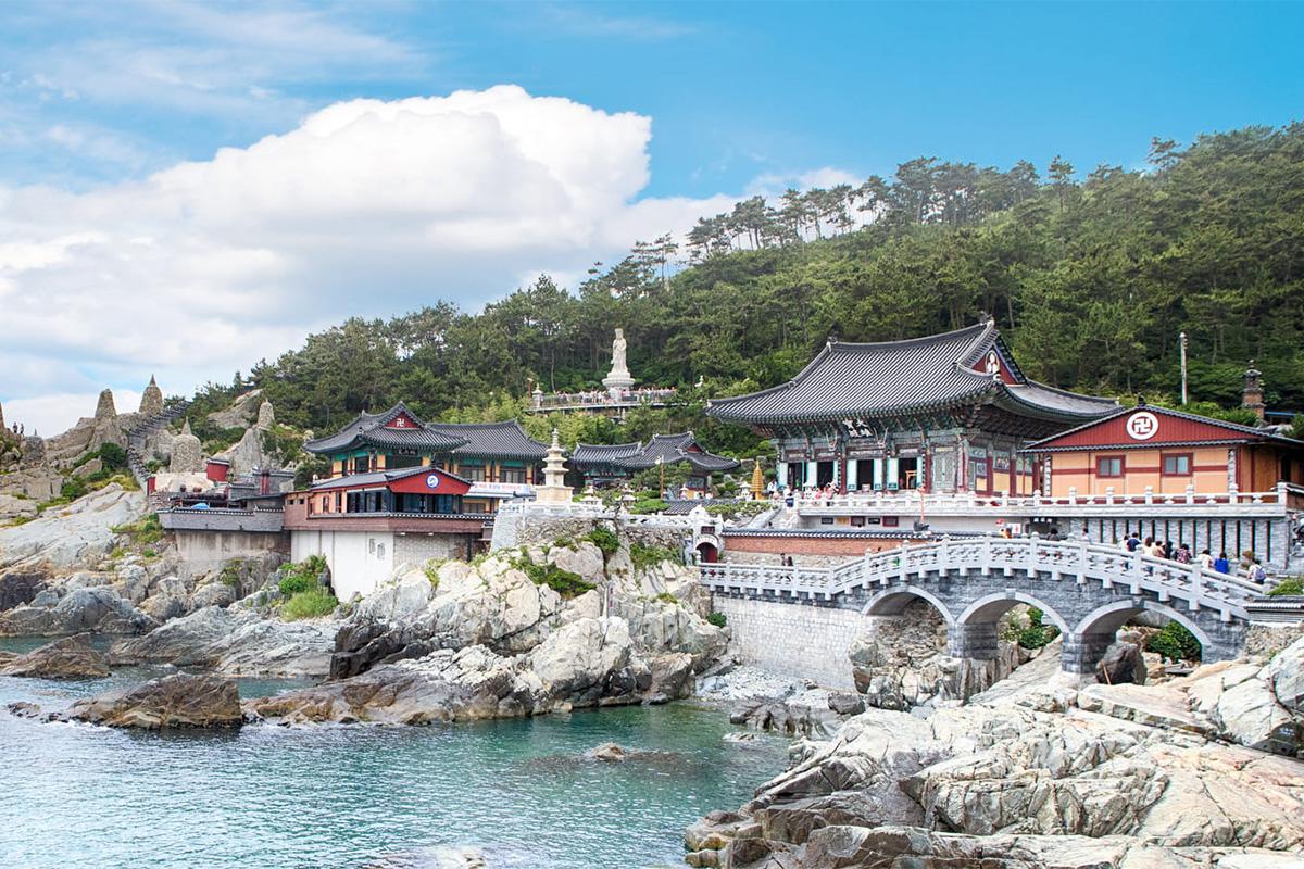 Picturesque view of Haedong Yonggungsa Temple perched on a rocky coastline overlooking the sea.