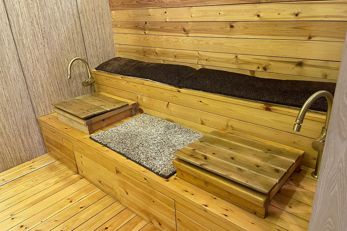 Wooden foot bath area at Happy Skin Myeongdong Spa designed for relaxation.