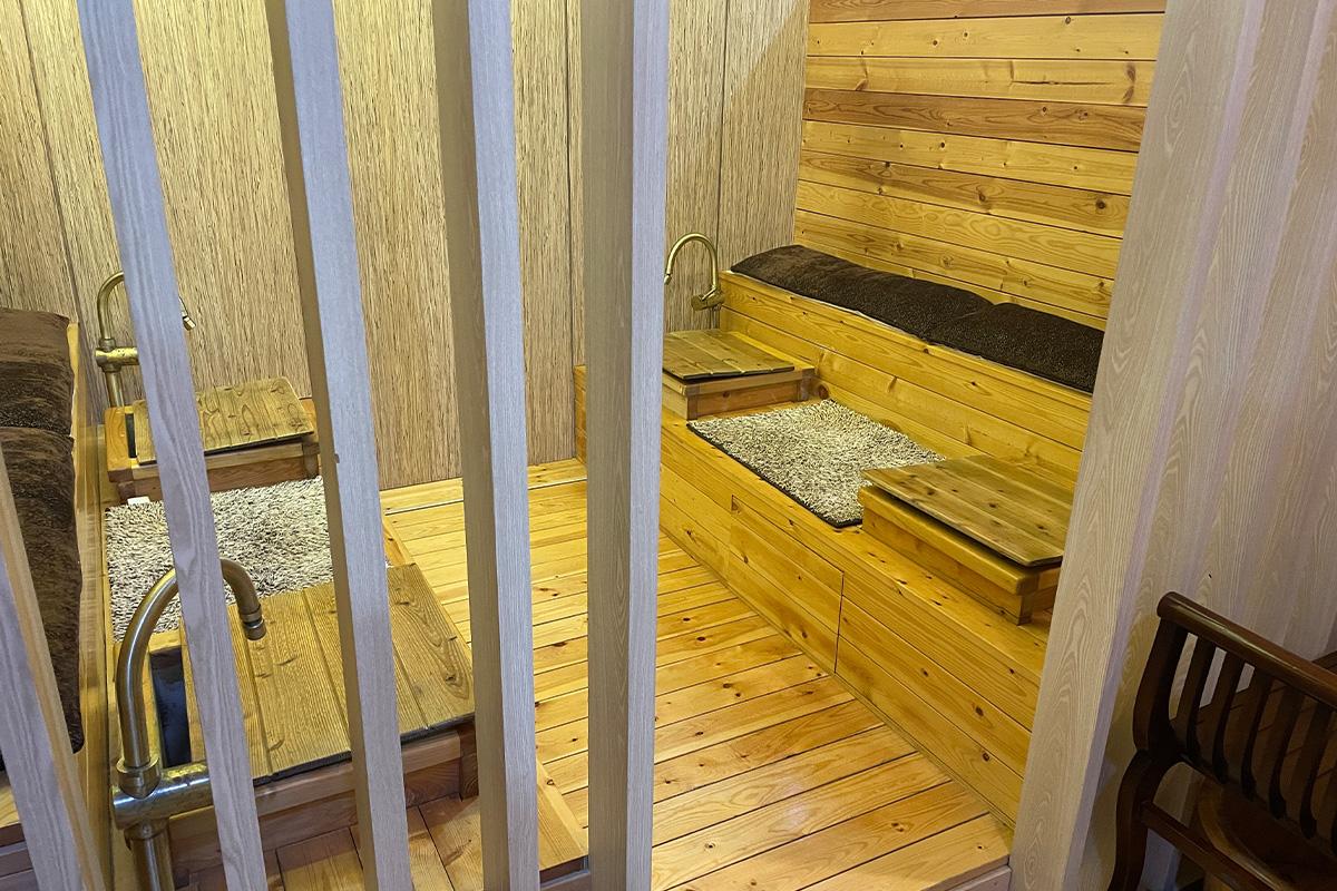 Close-up of wooden foot bath installation at Happy Skin Myeongdong Spa, providing a serene experience.