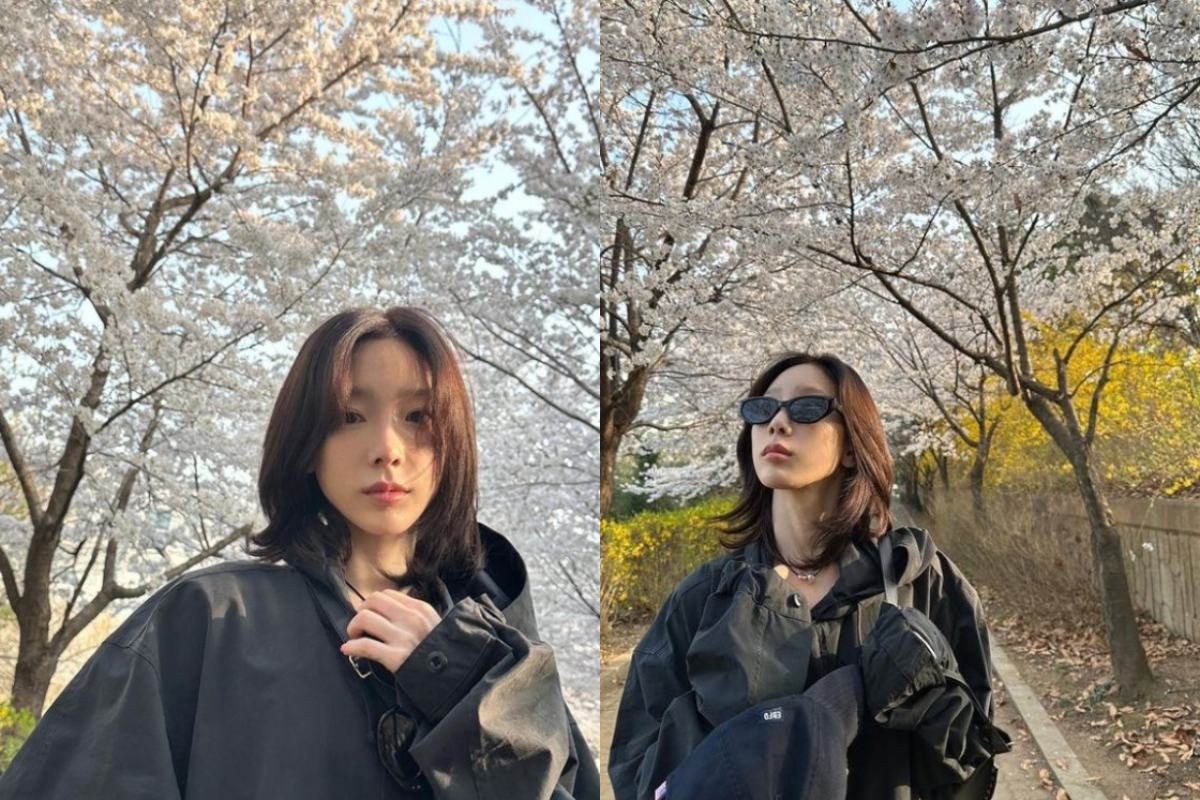 Taeyeon of Girls' Generation enjoying the serene beauty of cherry blossoms, epitomizing spring in Korea.