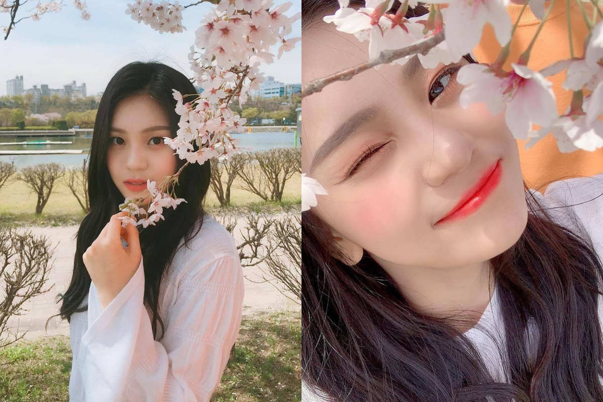 VIVIZ's Umji showcasing fun poses under cherry blossoms, highlighting the playful side of Korea's spring season.