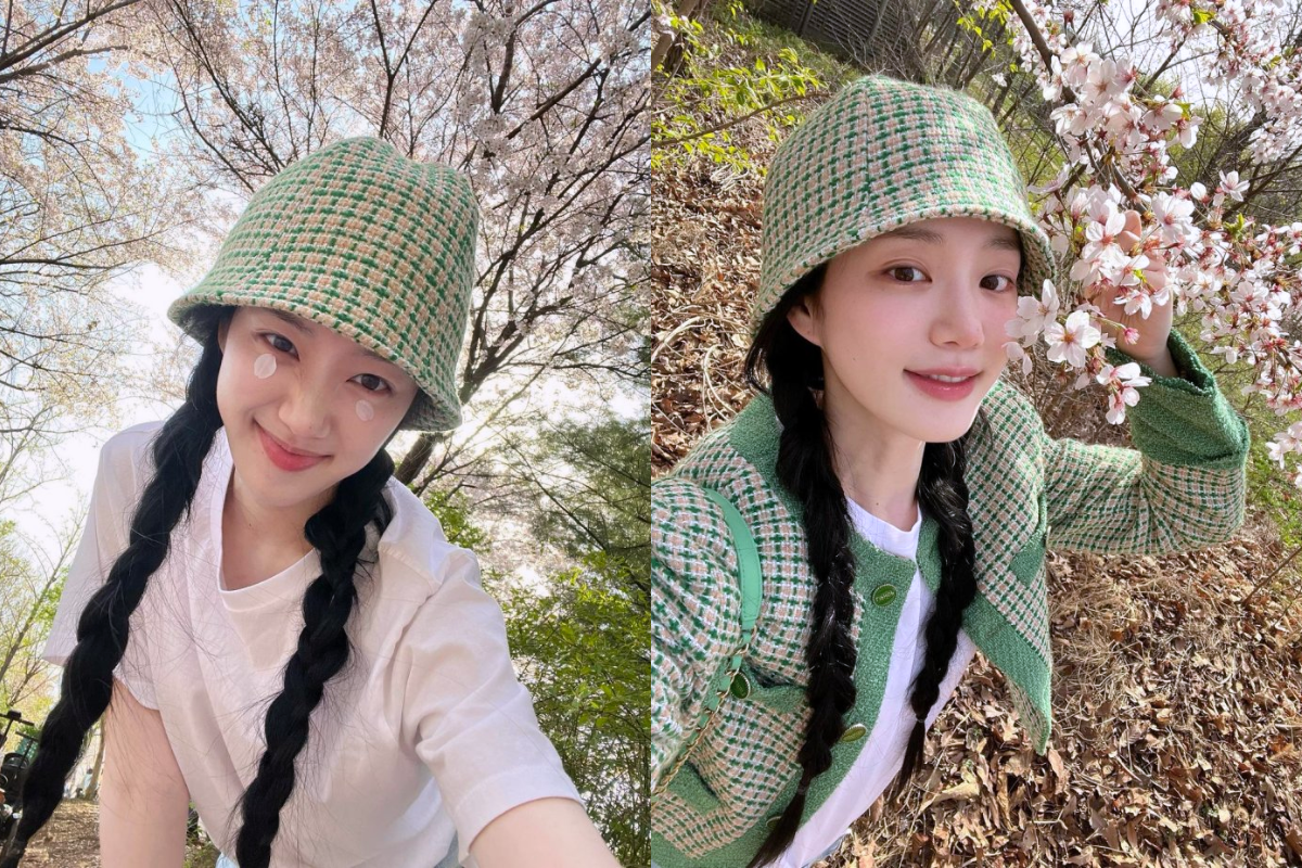 Woman posing under cherry blossom trees, showcasing the natural beauty and vibrant colors of spring in Korea.