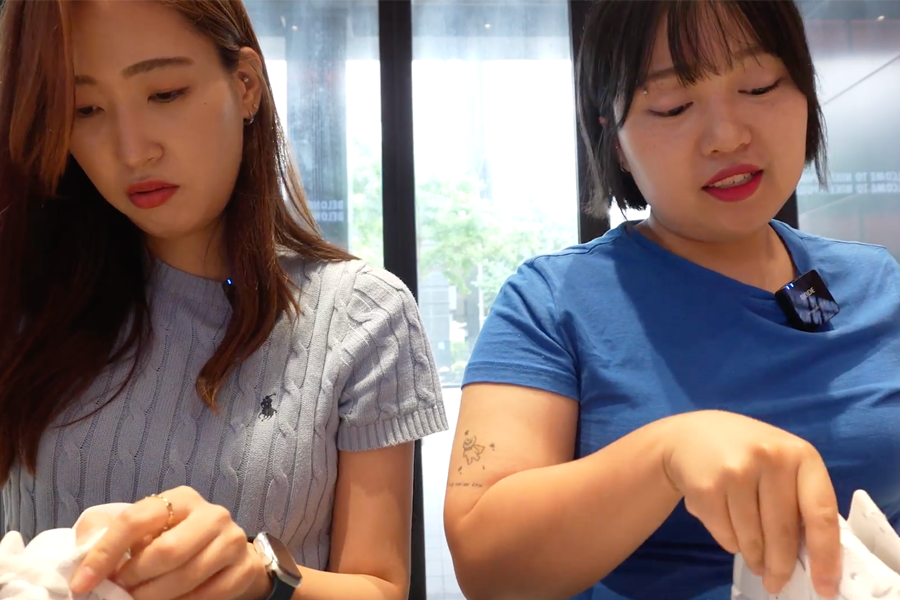 White-orange gradient Nike Air Force sneakers presented at the customization service