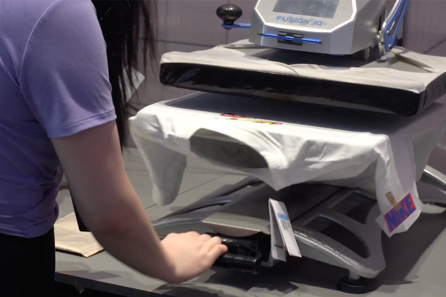 Close-up of a Nike T-shirt being printed with custom designs at Apgujeong store