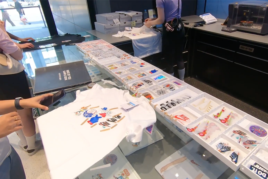 Custom Nike T-shirt design table with various patches at Nike By You Seoul
