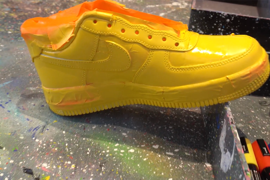 Bright yellow custom Nike shoes in the spraying stage at Apgujeong