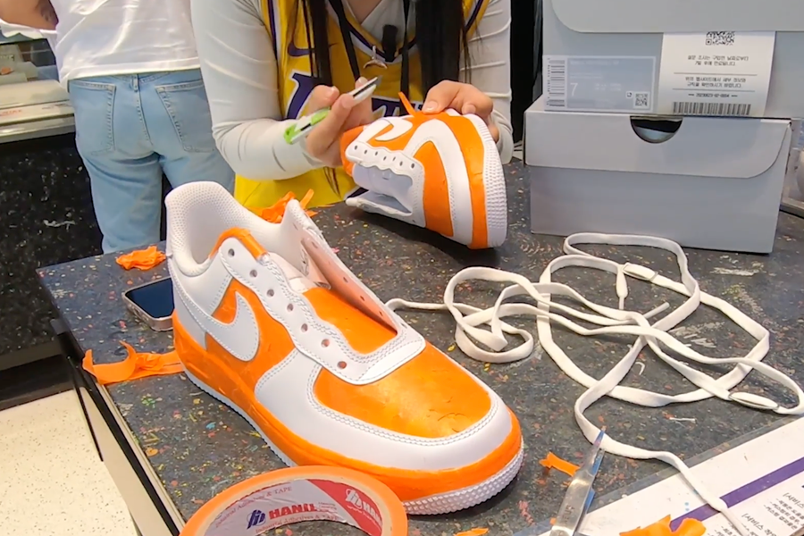 Nike Air Force sneakers being prepped for spray painting at customization studio