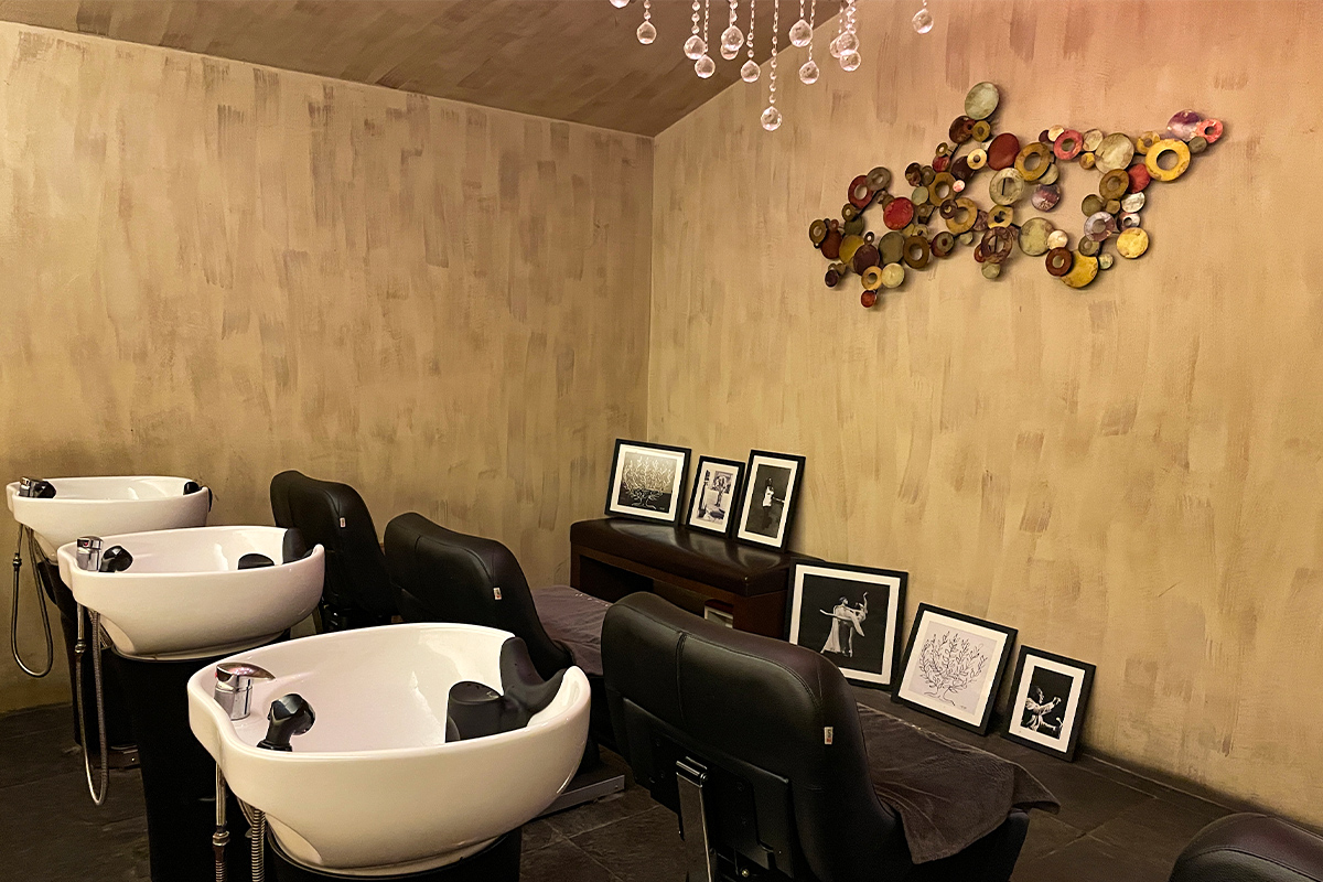 CHOP HAIR沙龍內的洗髮區,牆上掛著裝飾藝術圖。