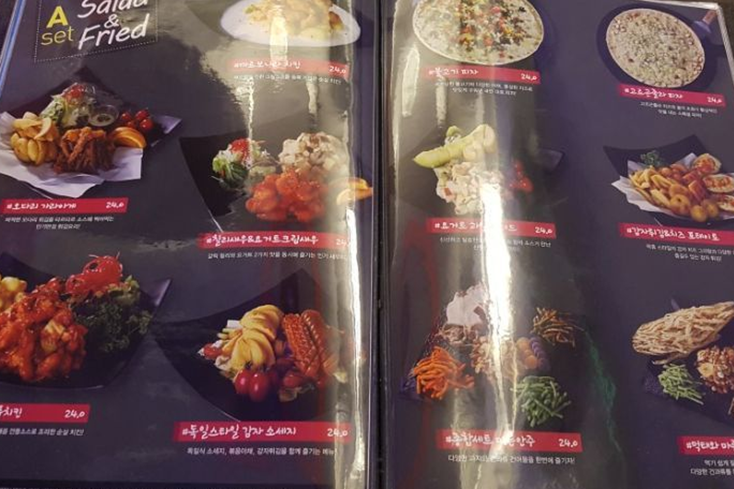 Close-up of a food menu page from a Korean karaoke town, showcasing various dishes to pair with entertainment.