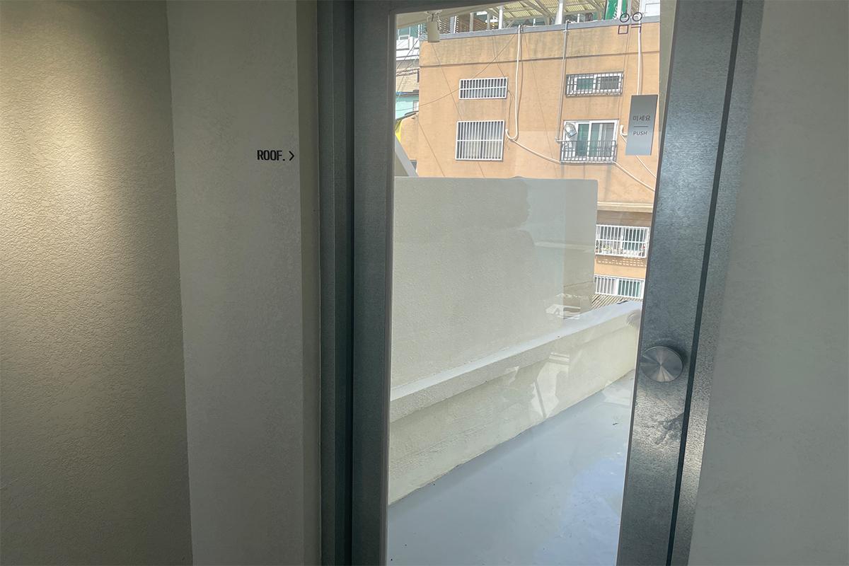 Stehlampe auf Natursteinbasis im spartanisch gestalteten Bereich des Yeoulmarq Cafe.