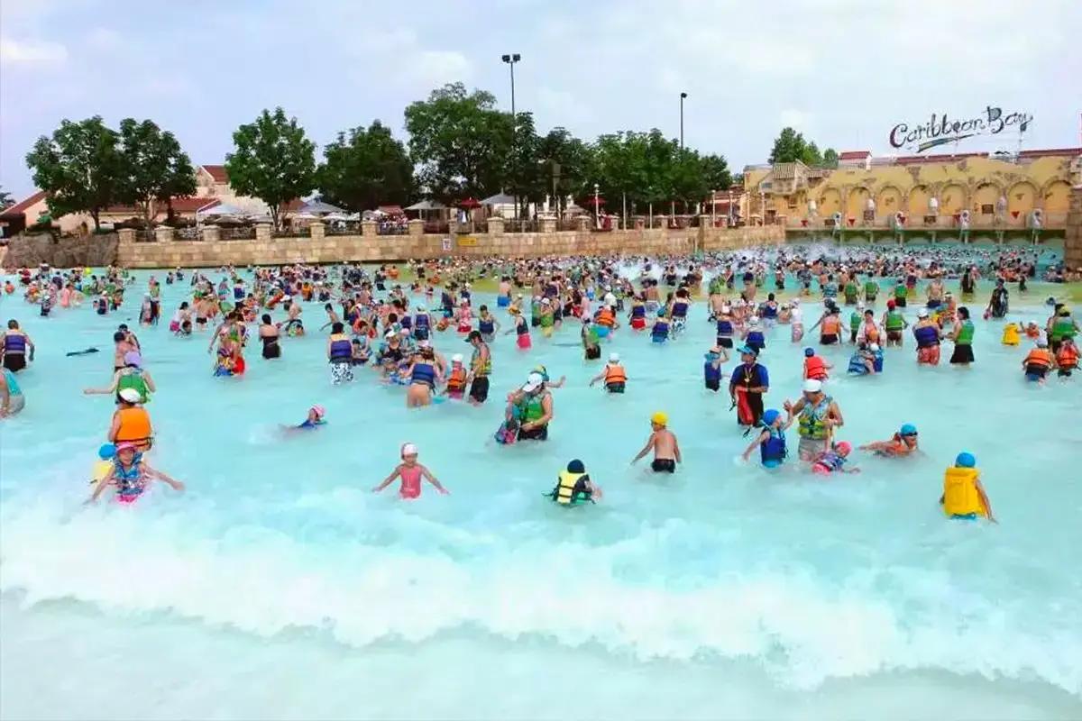 Crowds playing in the outdoor wave pool at Caribbean Bay