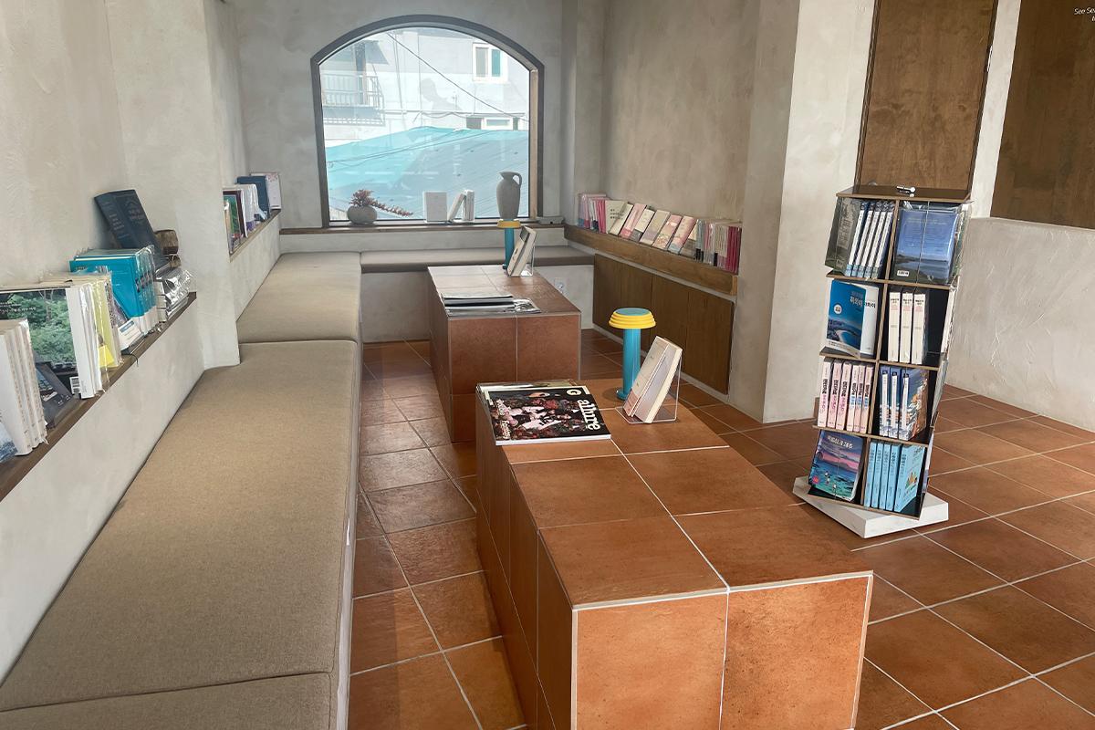 Зона отдыха с комфортным дизайном и выставкой книг в книжном кафе Sea Sea with Book.