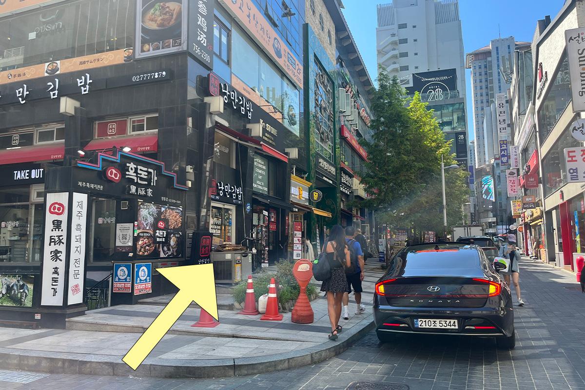 Street view in Myeongdong highlighting the route to SD Store with directional arrow for ease of navigation.