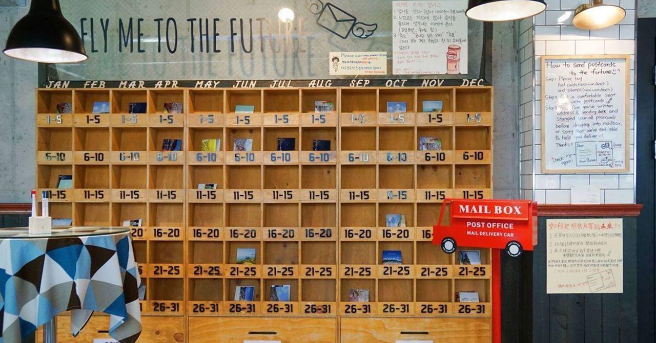 The creative layout of Busan's postcard future delivery service display in a cafe.